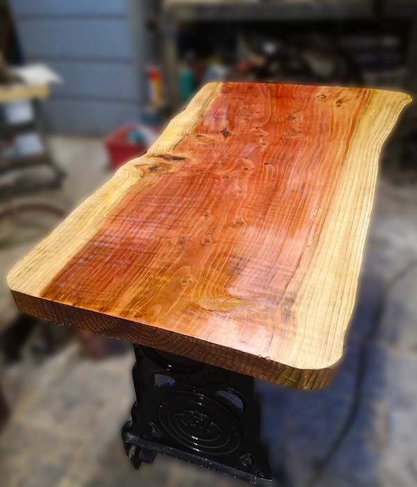 wany edge timber table mounted on old mangle base